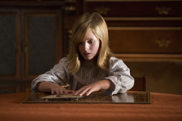 LULU WILSON as Doris in "Ouija: Origin of Evil."  Inviting audiences again into the lore of the spirit board, the supernatural thriller tells a terrifying new tale as the follow-up to 2014’s sleeper hit that opened at No. 1.  In 1965 Los Angeles, a widowed mother and her two daughters add a new stunt to bolster their séance scam business and unwittingly invite authentic evil into their home.  When the youngest daughter is overtaken by the merciless spirit, this small family confronts unthinkable fears to save her and send her possessor back to the other side.